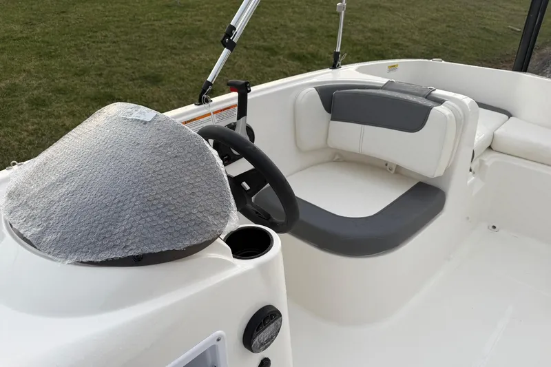 Slide: The Image of 2026 Bayliner Element E16 boat interior with steering wheel and seating area. - 13