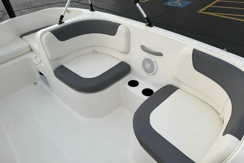 Slide: The Image of 2026 Bayliner Element E16 boat interior with cushioned seating and cup holders. - 14