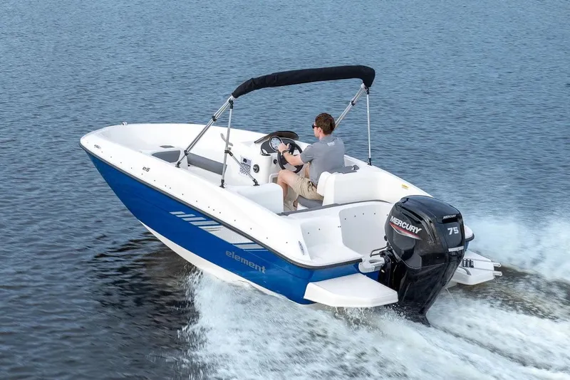 Slide: The Image of 2026 Bayliner Element E16 boat on trailer, parked outside a sales building. - 2