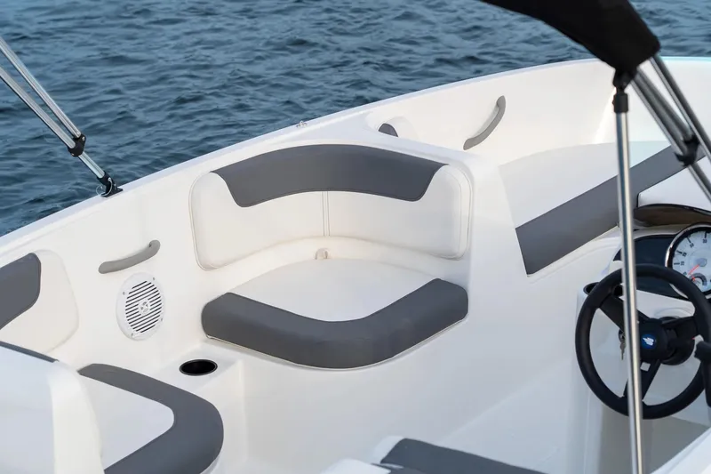 Slide: The Image of Manufacturer Provided Image: 2025 Bayliner Element E16 boat interior with gray seating, steering wheel, and water view. - 20