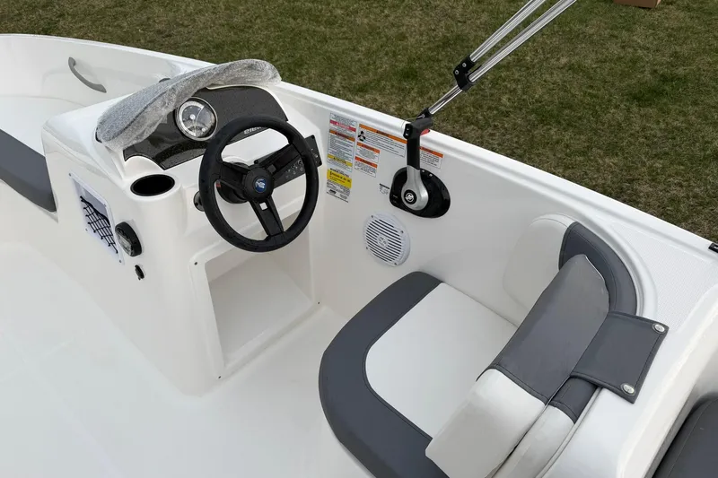 Slide: The Image of 2026 Bayliner Element E16 boat interior with steering wheel and seating. - 9