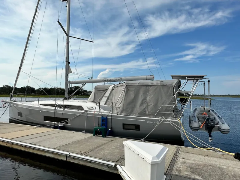 Slide: The Image of 2023 Beneteau Oceanis 46.1 sailboat docked, featuring sleek design and covered deck. - 1