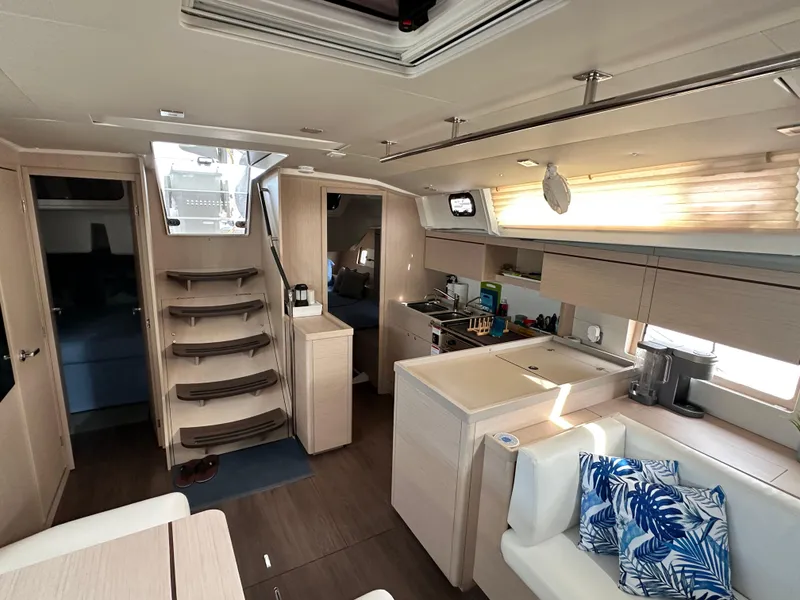 Slide: The Image of Interior of 2023 Beneteau Oceanis 46.1 yacht, featuring modern kitchen and seating area. - 37