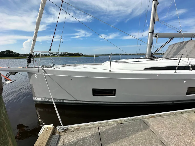 Slide: The Image of 2023 Beneteau Oceanis 46.1 sailboat docked by a serene waterfront. - 4