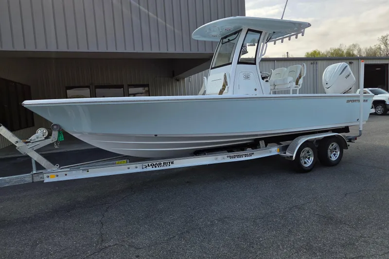 Slide: The Image of 2026 Sportsman Masters 247OE Bay Boat on trailer, parked outdoors. - 1