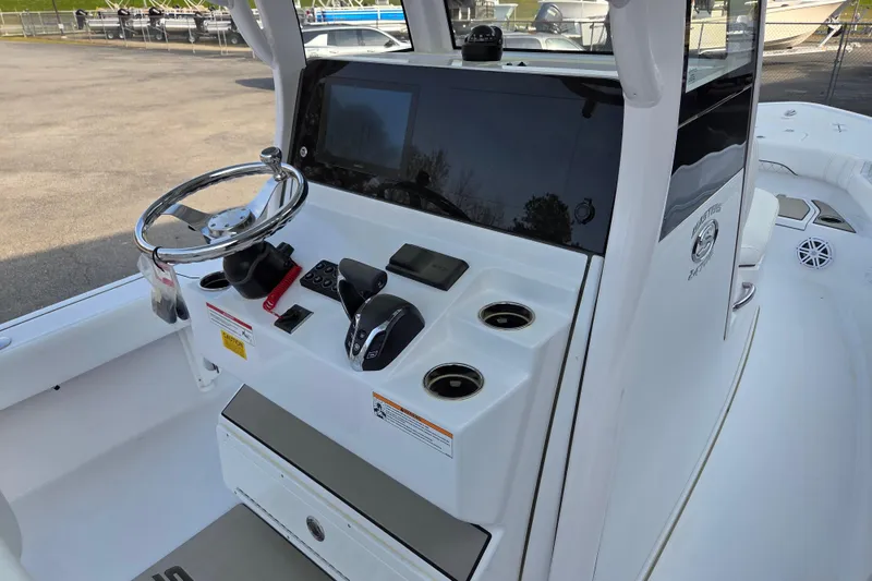 Slide: The Image of 2026 Sportsman Masters 247OE Bay Boat console with steering wheel and controls. - 11