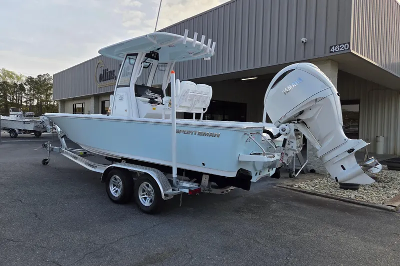 Slide: The Image of 2026 Sportsman Masters 247OE Bay Boat with Yamaha engine on trailer outside dealership. - 2