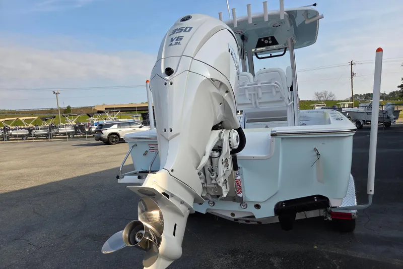 Slide: The Image of 2026 Sportsman Masters 247OE Bay Boat with powerful outboard motor in a marina setting. - 3