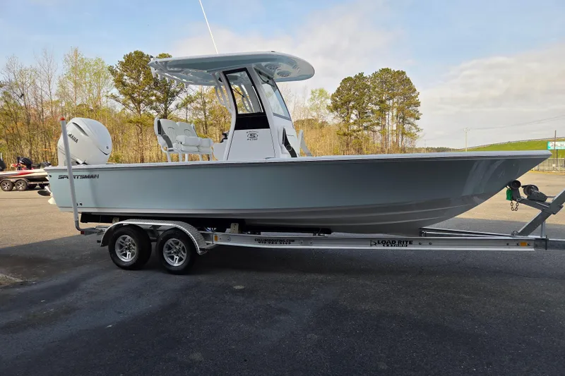 Slide: The Image of 2026 Sportsman Masters 247OE Bay Boat on trailer, parked outdoors. - 5