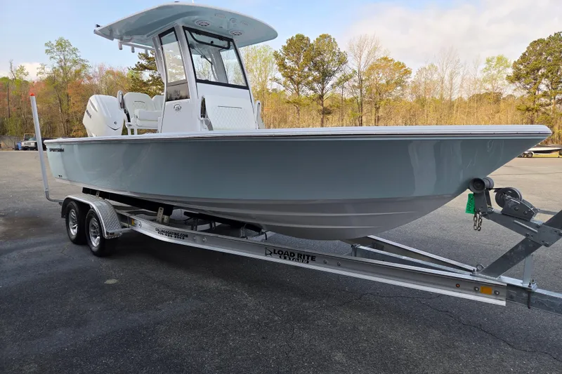 Slide: The Image of 2026 Sportsman Masters 247OE Bay Boat on trailer, parked outdoors. - 6