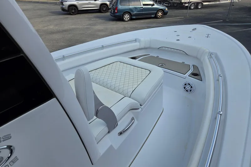 Slide: The Image of 2026 Sportsman Masters 247OE Bay Boat interior with cushioned seating and storage compartments. - 7