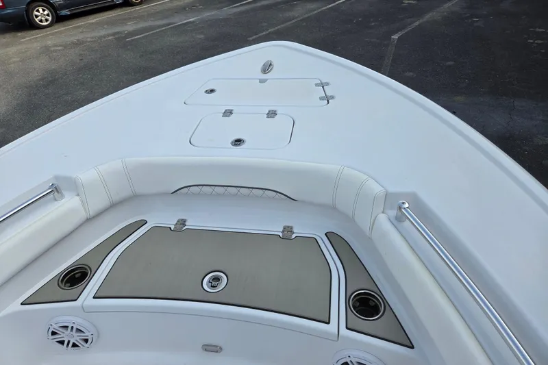 Slide: The Image of 2026 Sportsman Masters 247OE Bay Boat deck with storage compartments and seating. - 9