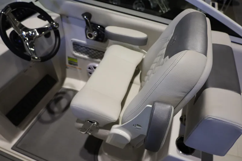 Slide: The Image of Captain's seat and steering wheel of 2026 Sailfish 236 DC boat interior. - 10