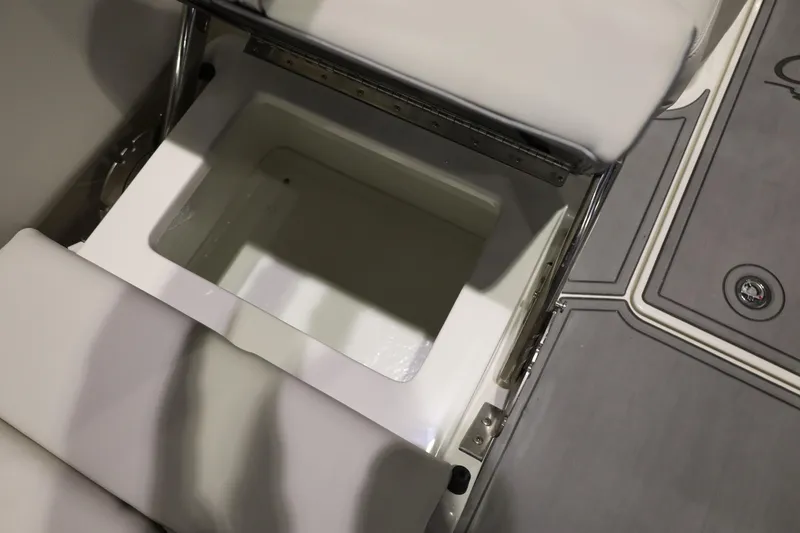 Slide: The Image of Open storage compartment on 2026 Sailfish 236 DC boat with cushioned seating. - 11