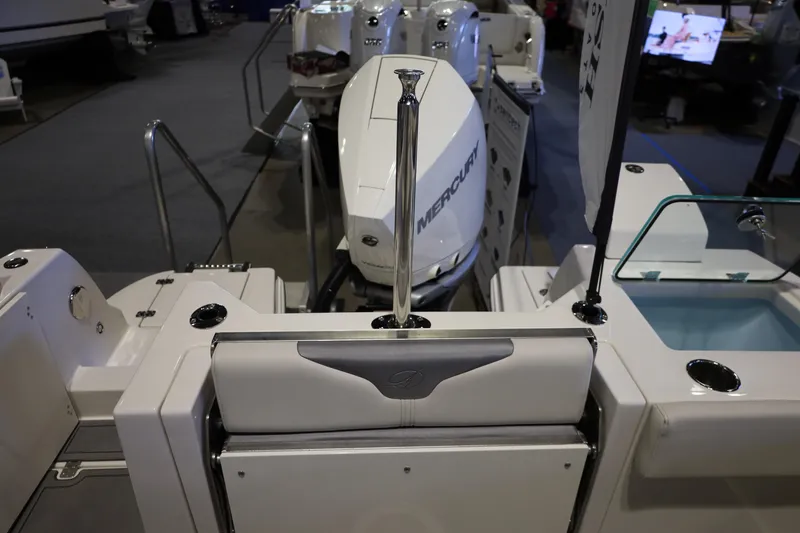 Slide: The Image of 2026 Sailfish 236 DC boat with Mercury outboard motor at a boat show. - 13
