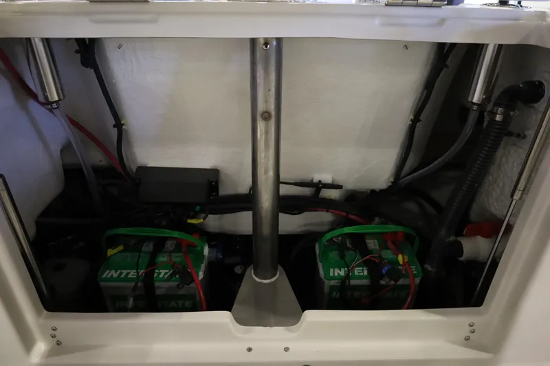 Slide: The Image of Battery compartment of 2026 Sailfish 236 DC boat, featuring dual Interstate batteries. - 14
