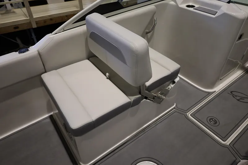 Slide: The Image of 2026 Sailfish 236 DC boat interior with cushioned seating and sleek design. - 16