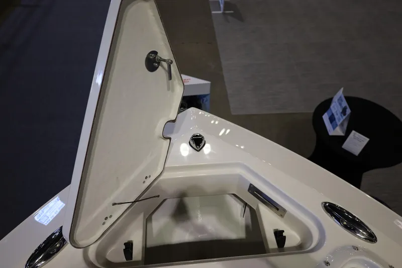 Slide: The Image of Open storage compartment on 2026 Sailfish 236 DC boat deck. - 23