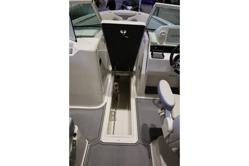 Slide: The Image of 2026 Sailfish 236 DC boat interior with open storage compartment and seating. - 27