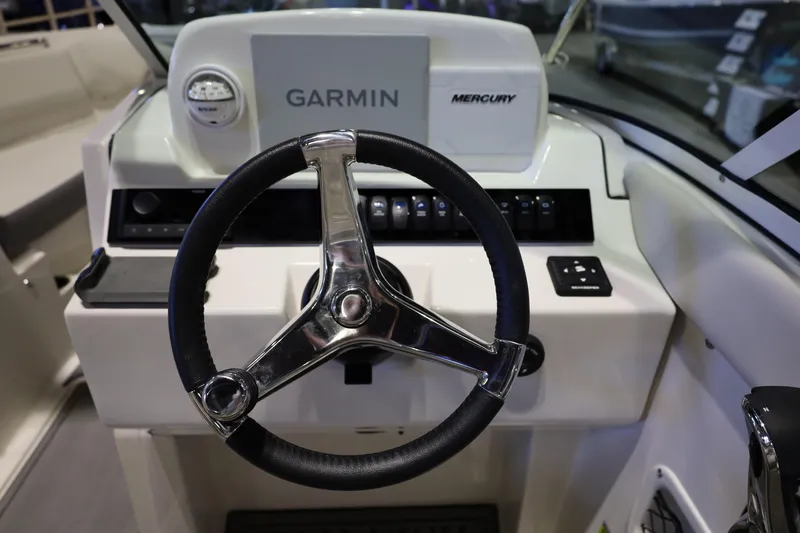 Slide: The Image of Steering wheel of 2026 Sailfish 236 DC boat with Garmin and Mercury controls. - 28