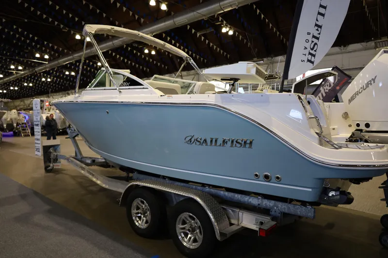 Slide: The Image of 2026 Sailfish 236 DC boat displayed indoors on a trailer. - 3