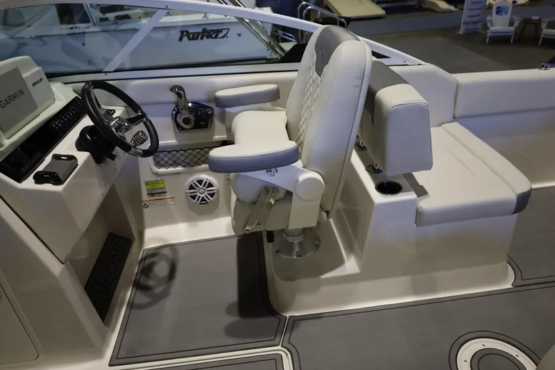 Slide: The Image of 2026 Sailfish 236 DC boat interior with steering wheel and cushioned seating. - 30