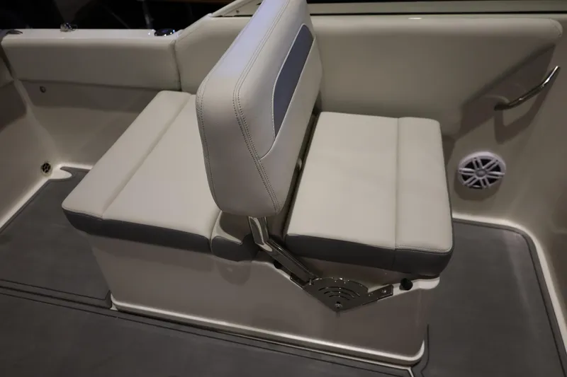 Slide: The Image of 2026 Sailfish 236 DC boat interior with cushioned seating and speaker. - 31