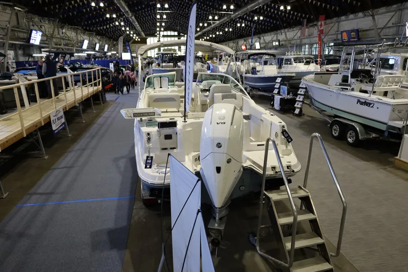 Slide: The Image of 2026 Sailfish 236 DC boat displayed at an indoor boat show. - 4