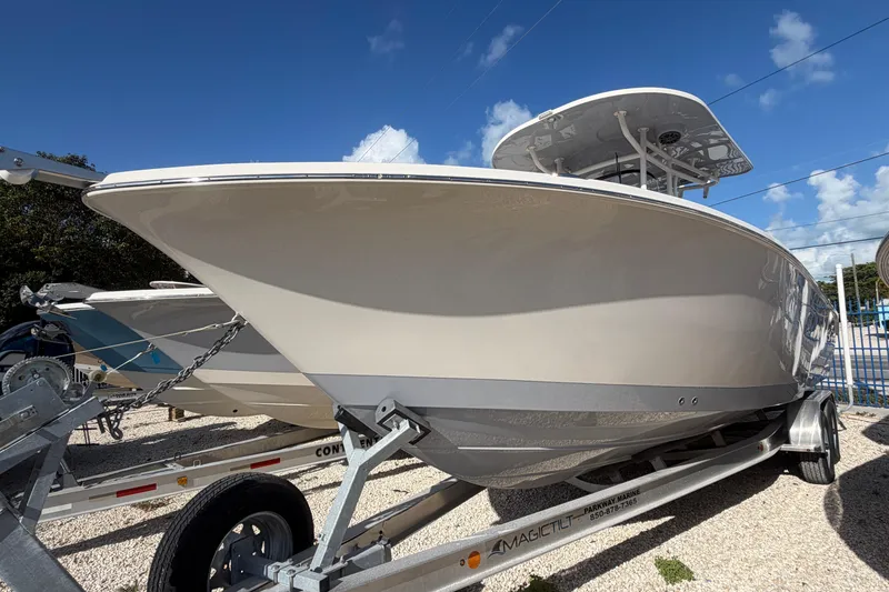 The Image of 2023 Sea Chaser 27 HFC CC boat on trailer under clear blue sky. - 1