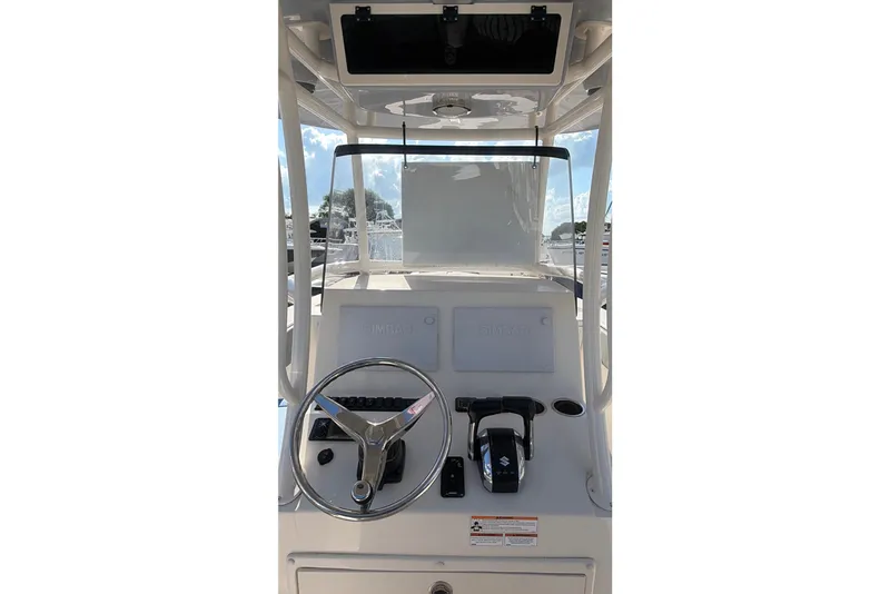 Slide: The Image of 2023 Sea Chaser 27 HFC CC boat helm with steering wheel and controls. - 11