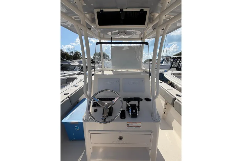 Slide: The Image of 2023 Sea Chaser 27 HFC CC boat console with steering wheel and controls. - 12