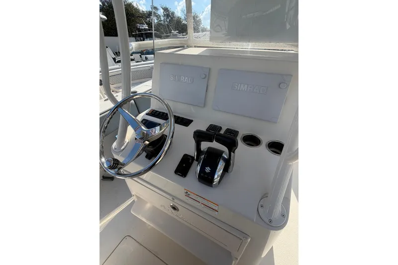Slide: The Image of 2023 Sea Chaser 27 HFC CC helm with Simrad displays and Suzuki controls. - 14