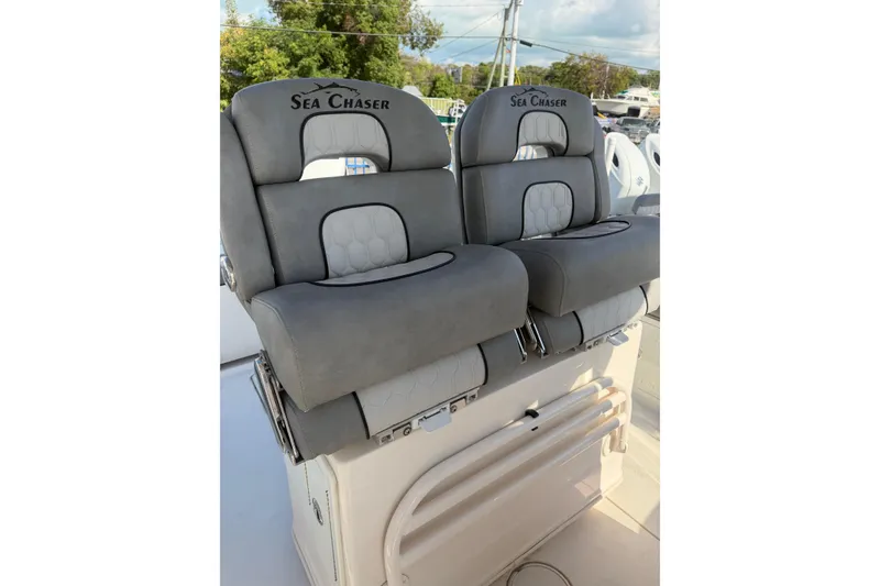 Slide: The Image of 2023 Sea Chaser 27 HFC CC boat seats, gray upholstery, dual seating arrangement. - 15