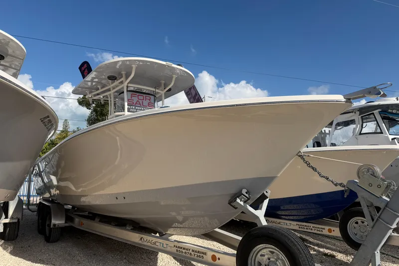 Slide: The Image of 2023 Sea Chaser 27 HFC CC boat for sale on trailer under clear blue sky. - 2