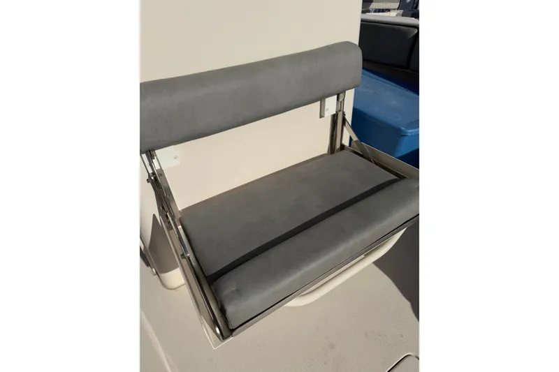 Slide: The Image of 2023 Sea Chaser 27 HFC CC boat seat with gray upholstery and foldable design. - 20