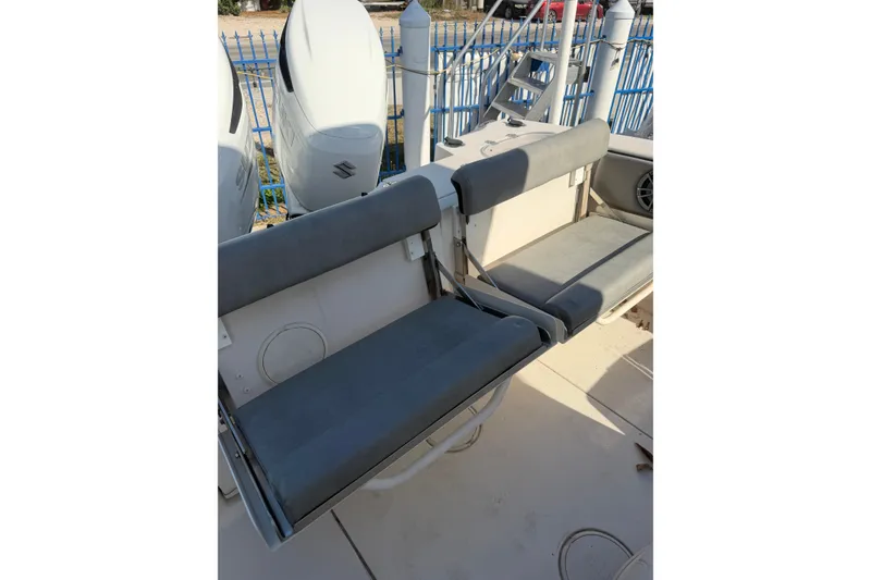 Slide: The Image of 2023 Sea Chaser 27 HFC CC boat seating area with dual outboard engines. - 23