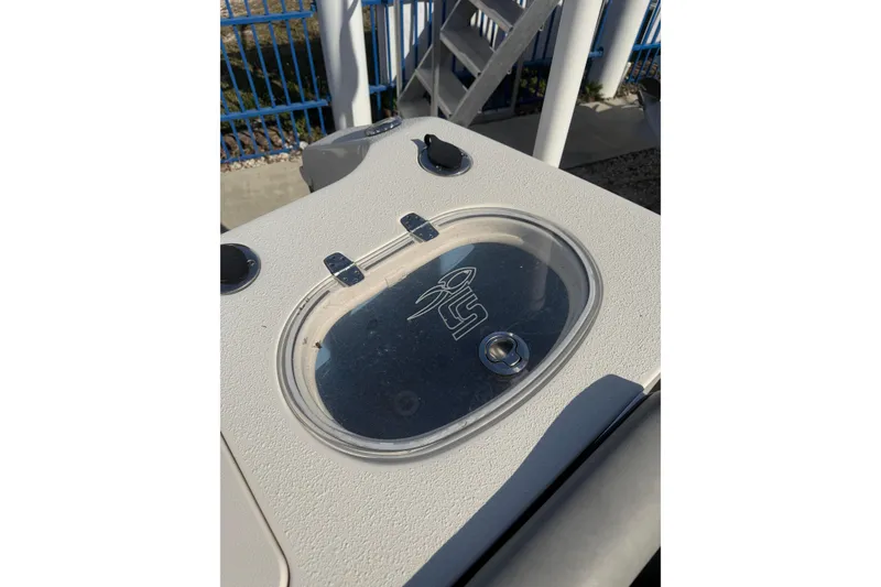 Slide: The Image of Livewell on 2023 Sea Chaser 27 HFC CC boat, featuring a clear lid and logo. - 9