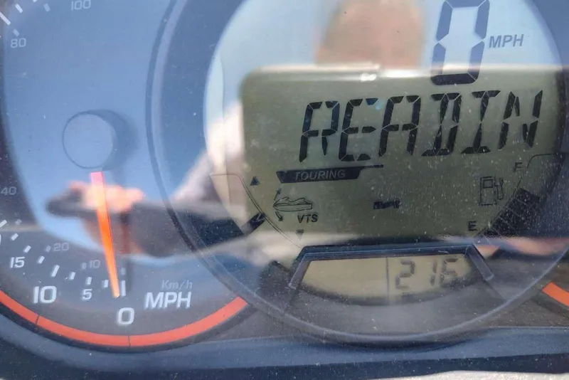 Slide: The Image of Dashboard of a 2015 Sea-Doo Wake Pro 215 showing 0 MPH and "READIN" display. - 2