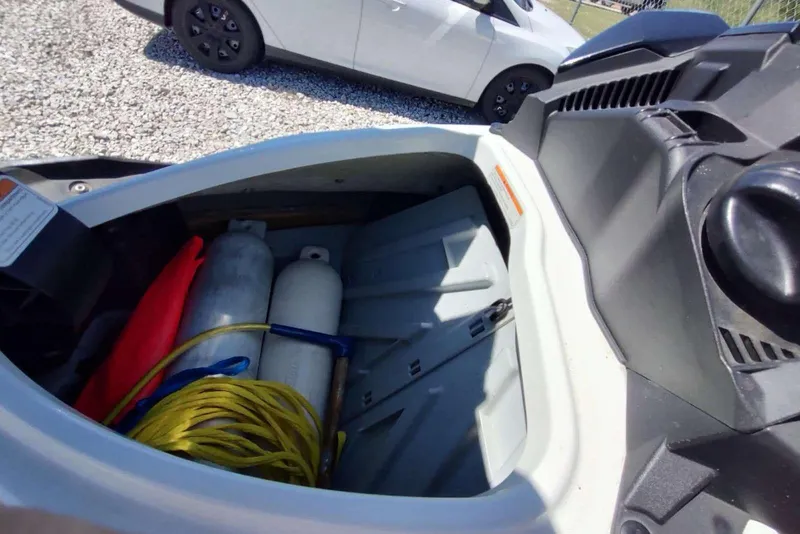 Slide: The Image of Open storage compartment of 2015 Sea-Doo Wake Pro 215 with equipment inside. - 5
