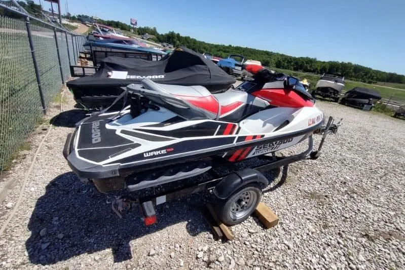 Slide: The Image of 2015 Sea-Doo Wake Pro 215 jet ski on a trailer, parked outdoors. - 7