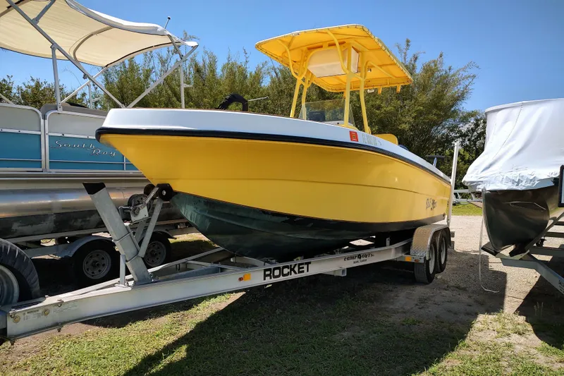 The Image of Yellow 2004 Angler 204 Center Console boat on trailer, parked outdoors. - 0