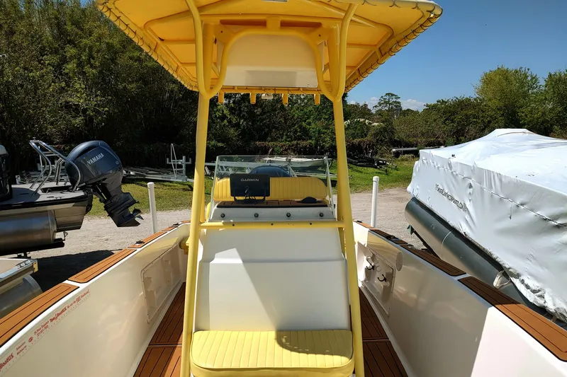 Slide: The Image of 2004 Angler 204 Center Console boat with yellow canopy and Garmin navigation system. - 10