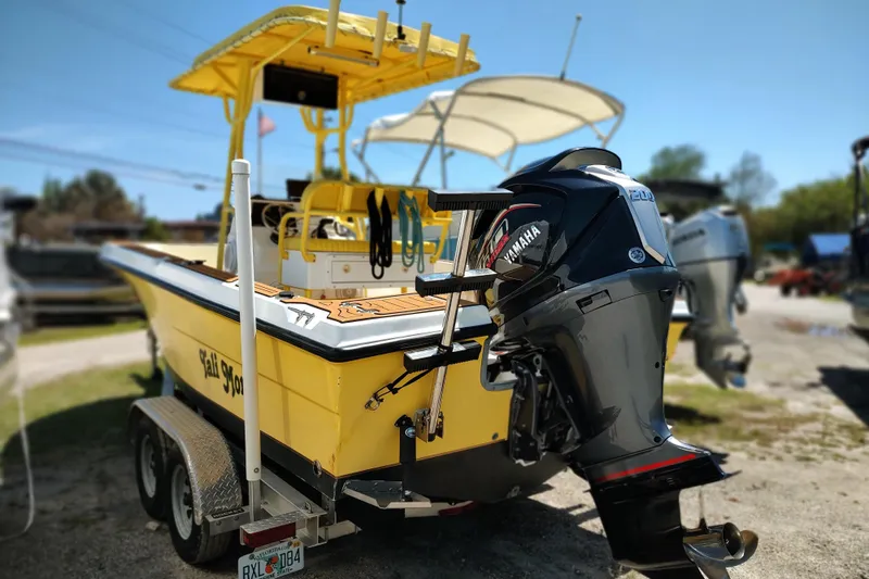 Slide: The Image of Yellow 2004 Angler 204 Center Console boat with Yamaha outboard motor on trailer. - 11