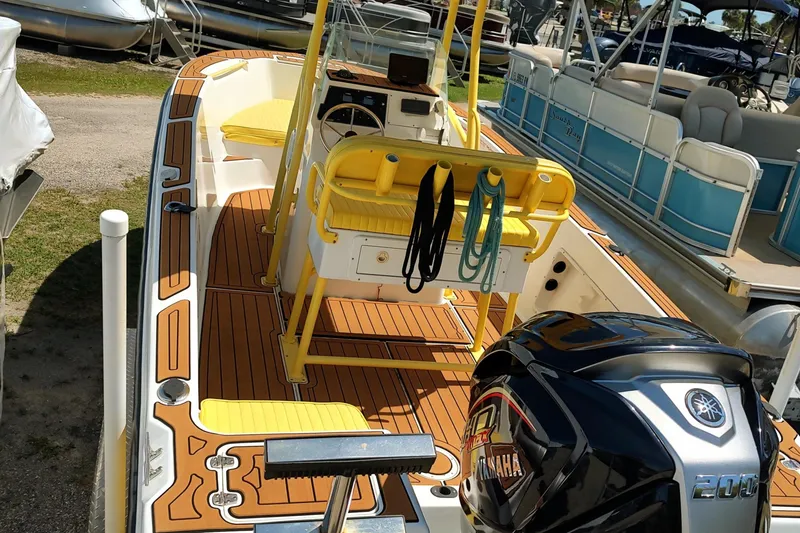 Slide: The Image of 2004 Angler 204 Center Console boat with Yamaha engine, docked among other boats. - 6