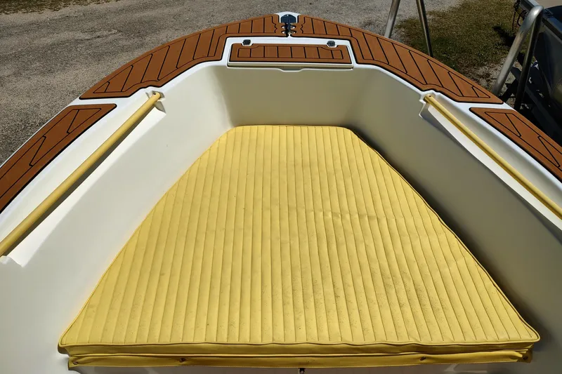 Slide: The Image of 2004 Angler 204 Center Console boat with yellow cushioned bow seating. - 7