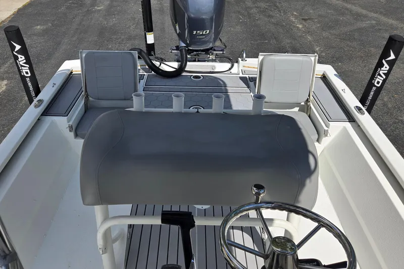 Slide: The Image of 2021 Avid 23 FS boat interior with steering wheel and seating arrangement. - 13