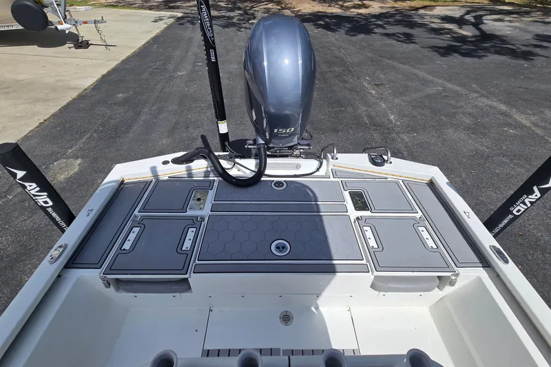 Slide: The Image of 2021 Avid 23 FS boat with Yamaha 150 engine, featuring sleek deck design. - 15