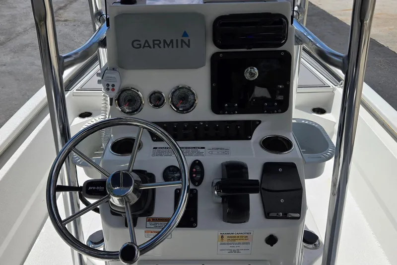 Slide: The Image of 2021 Avid 23 FS boat console with Garmin navigation and steering wheel. - 18