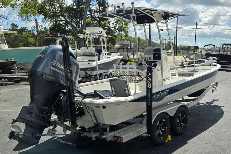 Slide: The Image of 2021 Avid 23 FS boat with Yamaha engine on trailer in sunny outdoor setting. - 3