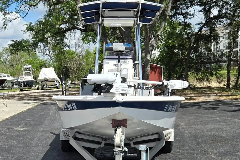 Slide: The Image of Front view of a 2021 Avid 23 FS boat on a trailer, parked outdoors. - 8